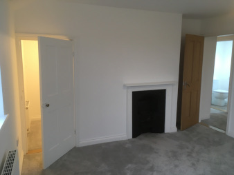 Bedroom 1, looking towards landing, showing walk-in cupboard and fireplace (not for use)